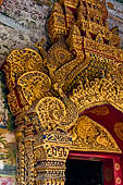 Luang Prabang, Laos - Wat Pa Phai the 'Bamboo Forest Monastery', detail of the main doorway gilded and covered with mosaics. 